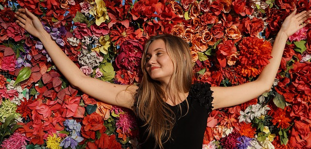 girl laying in a bed of flowers